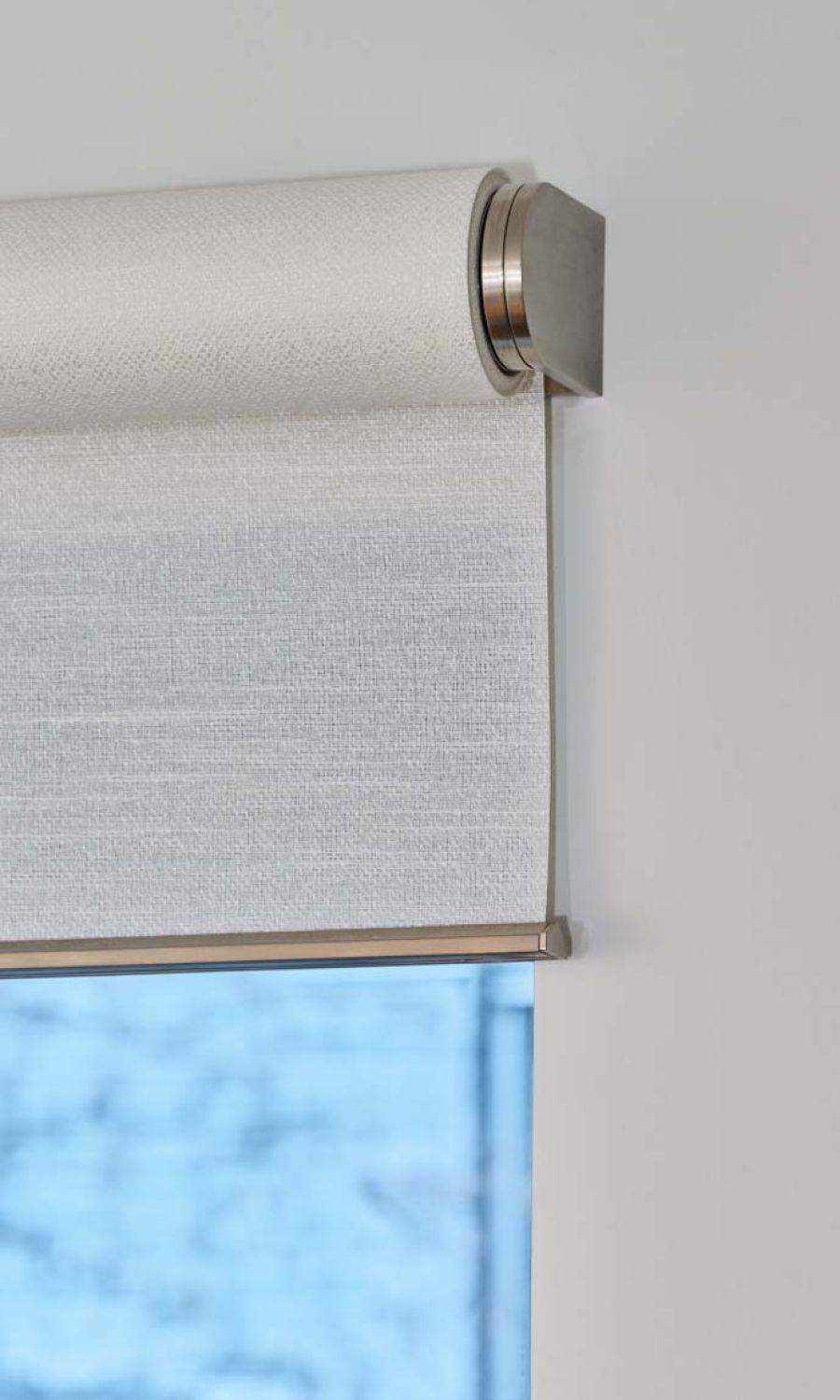 Close-up view of Lutron roller shades with a sleek design and textured fabric.