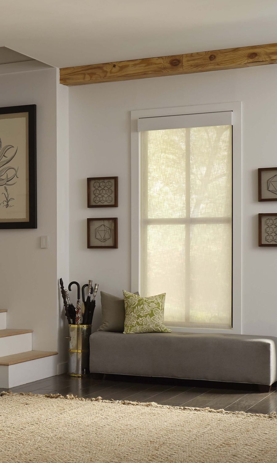 Modern living room with Lutron solar shades, a large sectional sofa, and a view of the city skyline.