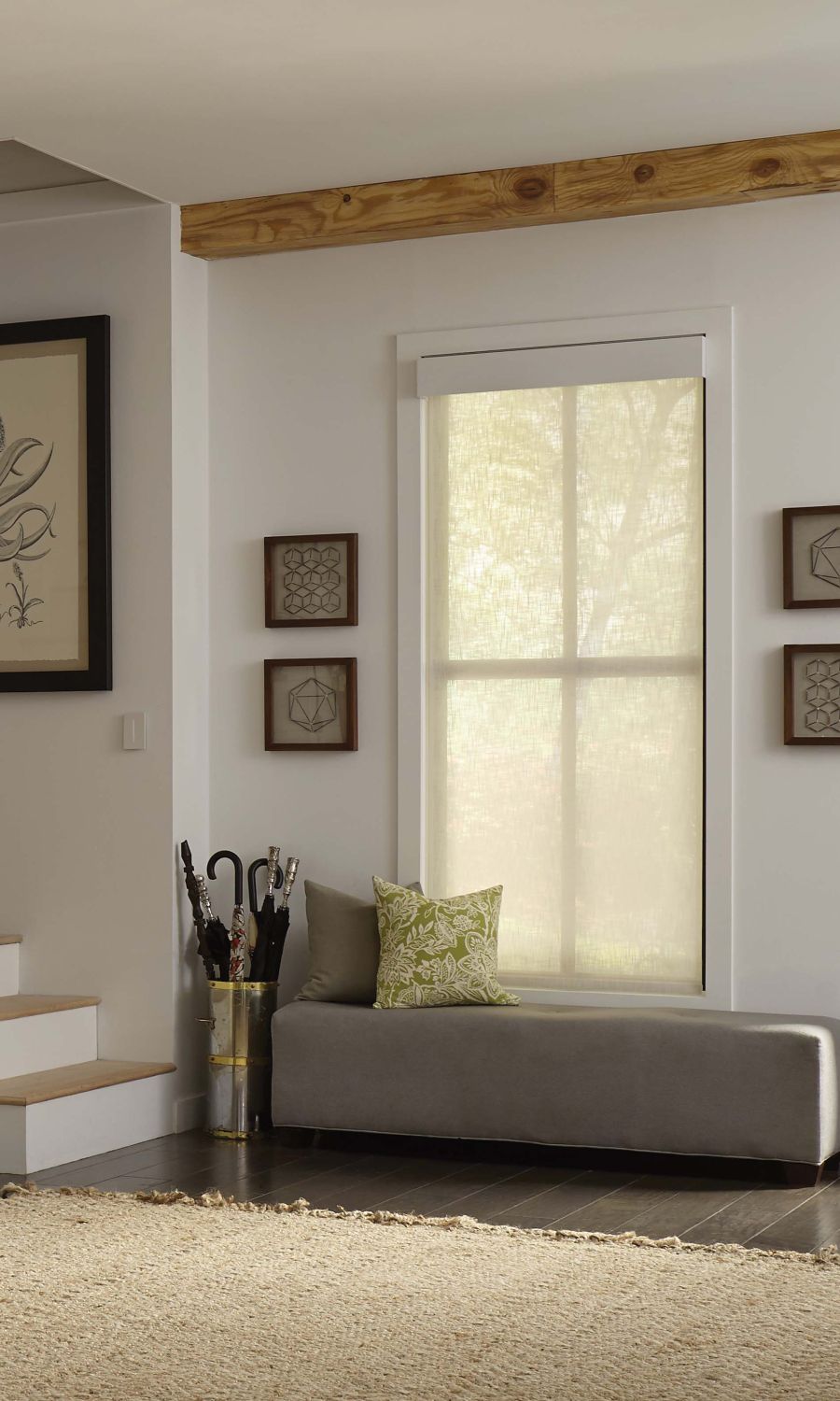 Modern living room with Lutron solar shades, a large sectional sofa, and a view of the city skyline.