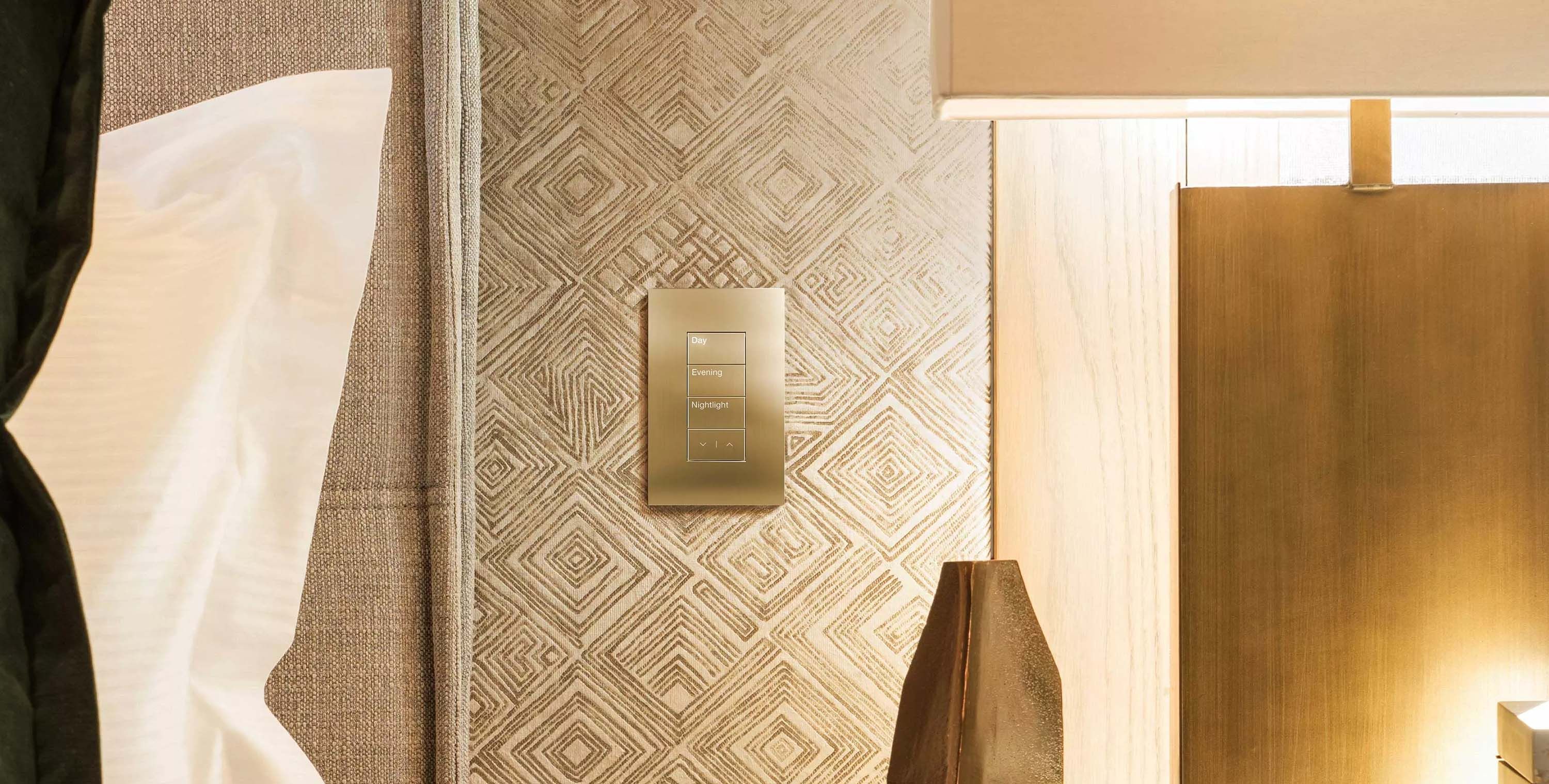 golden palladiom keypad on a wall with geometric wallpaper